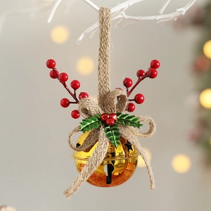 Christmas bell ornament with golden bells red berries and jute bow on a white branch