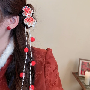 Detail of red koi fish embroidery hair clip with long pearl tassels and plush pom-poms