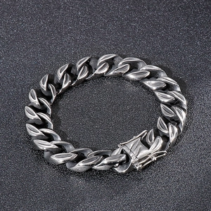 Macro shot of silver Cuban link bracelet detailing 316L stainless steel clasp engraving