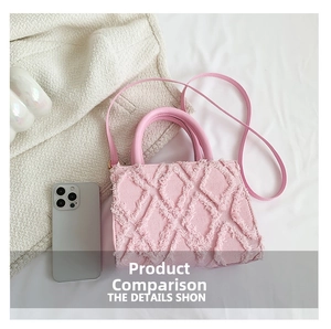 Pink fringed denim tote bag shown next to a smartphone for size and scale comparison