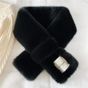 Detail shot of black faux fur scarf with elegant SEZF SERVICE woven label and cross-over design