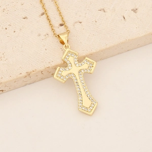 Macro view of a 18K gold-plated cross pendant necklace with colorful cubic zirconia