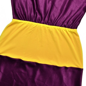 Detailed close-up of purple satin and yellow knit patchwork on a slim fit dress