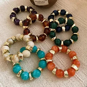 Acrylic beaded rings set with marble texture and golden metallic geometric accents