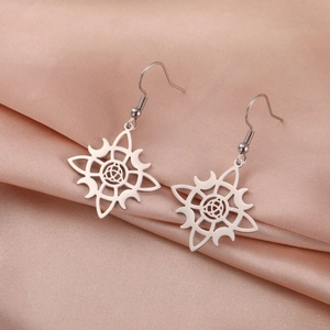 Elegant silver stainless steel witch knot moon earrings on champagne silk background