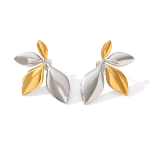Detail shot showing the polished dual-tone gold and silver leaf-shaped stud earrings