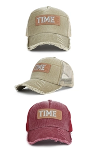 Close-up of vintage washed mesh baseball cap with embroidered patch and frayed brim detail