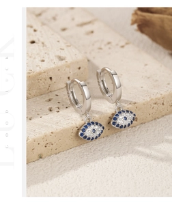 Detail of S925 sterling silver evil eye hoop earrings with blue stones and S925 hallmark
