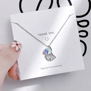 Close-up of silver tulip pendant with cubic crystal and pavé rhinestones on chain