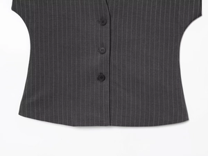 Close-up of a dark grey pinstripe vest featuring classic single-breasted black buttons