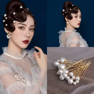 Set of bridal pearl U-shaped hair pins with gold wavy design for elegant wedding styling