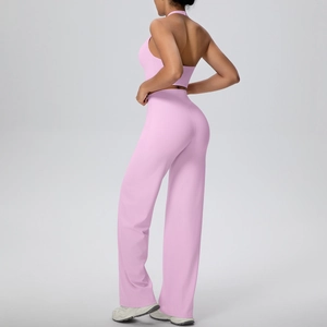Side view of light pink halter yoga set with backless sports bra and wide-leg trousers