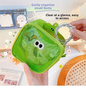 Handheld view of a bright green mesh storage bag with cartoon eye embroidery for cables