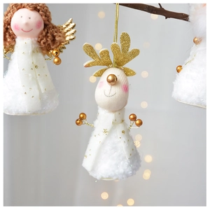 Close-up of plush angel and reindeer ornaments with golden sequins on a Christmas tree