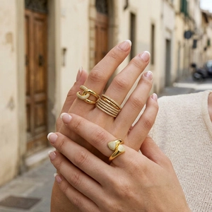 Close-up of 18K gold-plated multi-layer rings with sparkling cubic zirconia on hand