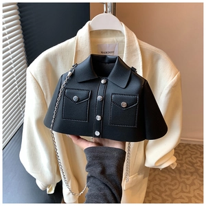 Detail of creative shirt-shaped black leather bag with collar, buttons and silver chain