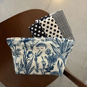 Macro shot of canvas cosmetic bags with floral patterns and durable metal zippers