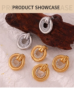 Detail showing gold and silver hoop earrings with micro-set zircons on bark texture