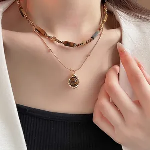 Double-layer gold plated tiger eye beaded necklace with pendant on a fashion model
