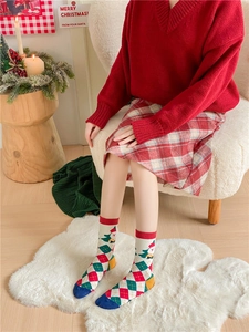 Cozy festive Christmas crew socks with Santa Claus pattern and classic red green plaid