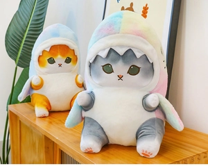 Plush cats in rainbow shark hoodies displayed as creative home decor on wooden shelf