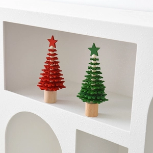 Miniature wooden Christmas trees in red and green with star toppers for desktop decor