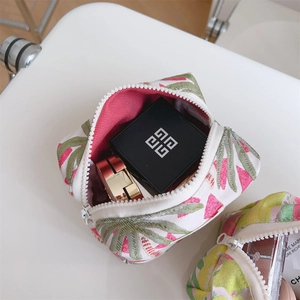 Internal view of rose pink jacquard makeup pouch with tropical leaf patterns and zipper