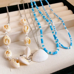 4-piece bohemian layered necklace set with natural shells and ocean style beads