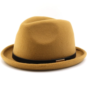 Detail of wool felt fedora hat in mustard yellow with black band and gold metal buckle