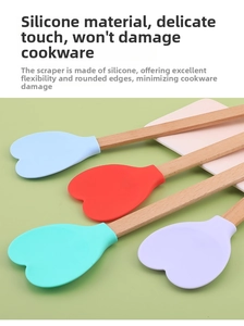 Close-up of heart-shaped silicone spatulas with ergonomic natural beech wood handles