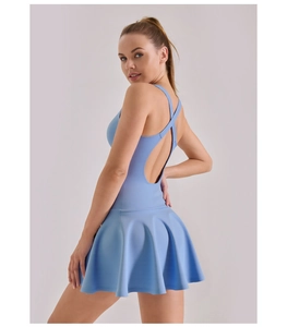 Back view of light blue athletic dress showing cross straps and pleated skirt hem