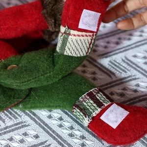 Detail of Christmas curtain buckle showing red green felt fabric and velcro fastener