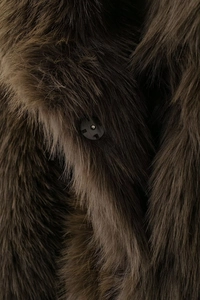 Detailed close-up of dark grey faux fur texture and a black round button on the coat