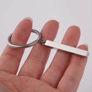Macro shot of silver brushed stainless steel bar keychain with metal ring detail