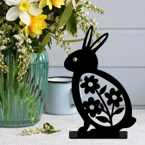 Easter rabbit cutout with floral patterns on a table with fresh spring flowers