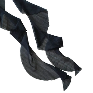 Close-up of black mesh fabric trim with delicate ruffled edges for elegant dress decoration