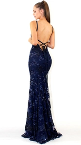 Detail of cross-back straps on a navy blue sequined fishtail evening gown