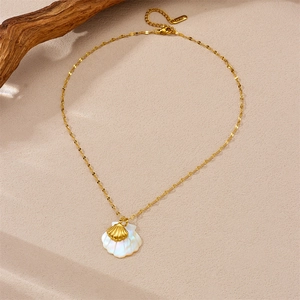 18K gold plated stainless steel shell pendant necklace on beach-themed background