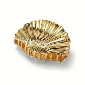 Golden shell metal hair claw clip with elegant texture for summer beach vacation
