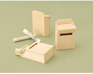 Detailed close-up of miniature wooden dollhouse mailboxes with tiny rolled newspapers