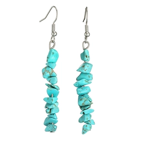 Macro shot of long drop earrings with natural turquoise stone chips and silver hooks