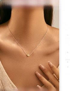 Detail of s925 silver necklace featuring a sparkling oval yellow gemstone pendant on a model