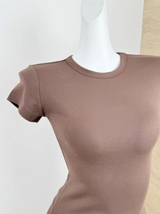 Detail of dark brown ribbed knit fabric on a slim fit crew neck short sleeve athletic T-shirt