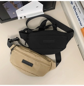 Detail view of water-resistant nylon waist bags in black and khaki with plastic buckles