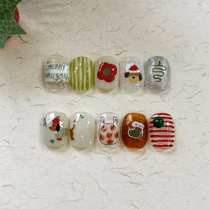 Christmas theme press-on nails featuring Santa dogs, trees and festive patterns