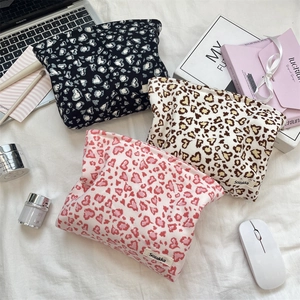 Detailed view of corduroy cosmetic bags set with heart leopard print and zipper closure