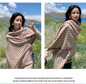 Detailed texture of brown houndstooth wool knitted scarf on model in outdoor setting