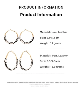 Detailed view of round and teardrop earrings with black and white wavy faux leather texture