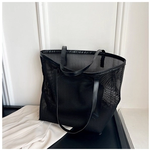 Detail of black mesh tote bag with durable PU leather handle and spacious design