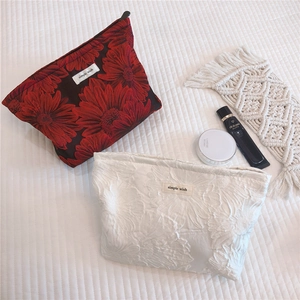 Macro detail of high-quality jacquard floral fabric texture and zipper on makeup bags